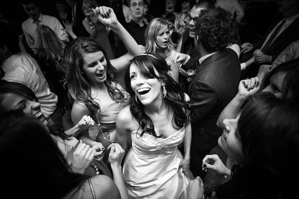 Black and white photo - Bride and bridesmaids dancing at the reception - wedding reception photo by Michael Norwood Photography